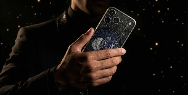 Custom Caviar iPhone with an artistic back panel held against a dark, star-filled background